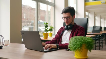 Wall Mural - camera flies around developer writing program code on computer display alone in office. freelancer t