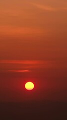 Wall Mural - timelapse of dramatic sunrise with orange sky in a sunny day.
