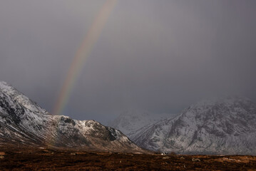 Wall Mural - Majestic landscape image of vibrant rainbow in front of mountains in Scottish Highlands Rannoch Moor Stob Dearg