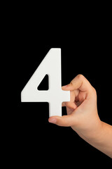 Aufkleber - Number four in hand isolated on black background. Number four in a child's hand, holding on a black background. To be inserted into a project or design.