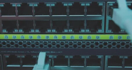Wall Mural - flickering light of server room falls on input and output ports of large network server switch