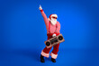Full length body size view of his he nice handsome bearded fat overweight cheery Santa having fun festive listening stereo dancing isolated bright vivid shine vibrant red color background