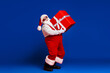 © deagreez - Full length body size view of his he attractive cheerful Santa father carrying big large giftbox fast delivery sale discount isolated bright vivid shine vibrant red color background