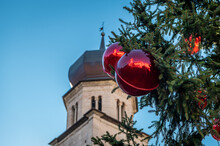 Christmas Trento: Christmas Tree Decorated With Red Balls With Reflection And The Cathedral In The Background - Selective Focus  With Shallow Depth On Field- Trentino Alto Adige - Northern Italy