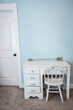 © Ursula Page - A small white child's desk and chair in a pale blue bedroom in a new construction house