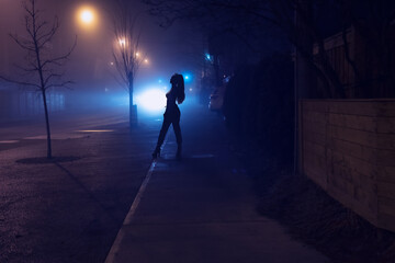 woman posing for photography on a foggy night