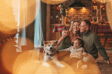 Candid authentic happy family during wintertime together enjoying holidays with dog at Xmas