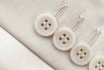 Wall Mural - Buttons on the sleeve of a white men's jacket. White button closeup