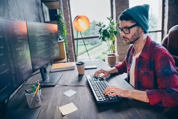 Photo of serious clever programmer wear spectacles writing content modern device indoors workplace workshop home