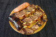 Wooden plate with typical Argentine meat barbecue. Pork steak, blood sausage and Creole chorizo