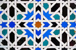 Geometric seamless andalusian moroccan islamic arabic star pattern in blue made out of ceramic tiles in Spain Sevilla