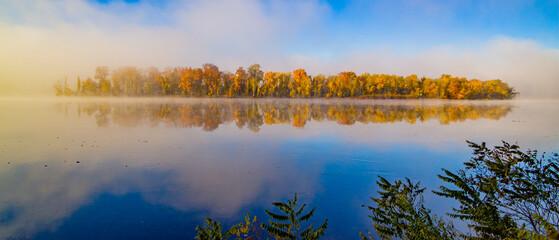 Wall Mural - autumn forest on the riverside, marvel at the amazing views of the island. fall foliage in connectic