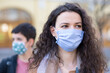© Solid photos - Two young women in the city wearing masks and gloves during corona virus pandemic