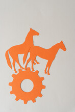 Orange Paper Horses And Cogwheel On Blank Paper