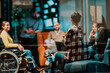 © .shock - Businesswoman in wheelchair having business meeting with team at modern office. A group of young freelancers agree on new online business projects