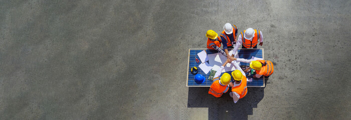 Top view of Architect engineers working on solar panel and blueprints. Technology solar cell, Service engineer for checking and planning the installation of solar cells on the roof warehouse factory