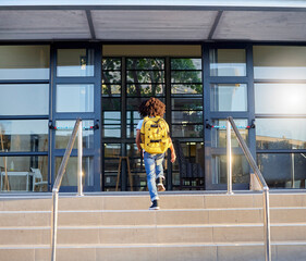 Poster - Child, walking and school entrance for education, learning or childhood development at academy building. Kid having a walk up the steps ready for back to school morning with backpack for knowledge