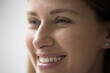 © fizkes - Cropped close up part of female face, happy young Caucasian woman portrait look aside, having white-toothed smile, wrinkles around eyes, staring into distance. Natural beauty, skincare treatments ad