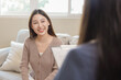 © KMPZZZ - Psychology, depression. smile asian young woman patient mental explained symptom with psychologist, psychiatrist while doctor woman taking notes at clinic. Encouraging, therapy.