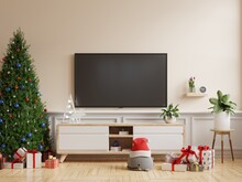 Christmas Room With TV Cabinet In Modern Living Room On Cream Wall Background.