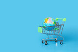 Fototapeta Mapy - Internet shopping, online purchases, international delivery, planet earth in a trolley, copy space