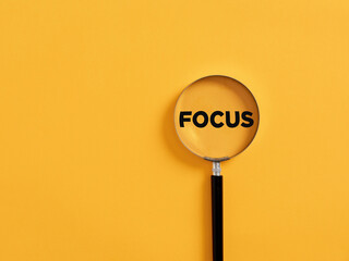 Wall Mural - Magnifier focuses on the word focus. glass. Focusing or concentration on an issue in business or education