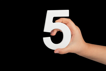 Aufkleber - Number five in hand isolated on black background. Number five in the hand of a child holding on a black background. To be inserted into a project or design.