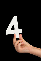 Aufkleber - Number four in hand isolated on black background. Number four in a child's hand, holding on a black background. To be inserted into a project or design.