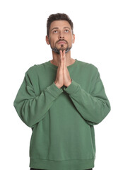 Wall Mural - Man with clasped hands praying on white background