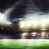 Fototapeta Sport - American Football field illuminated by stadium lights