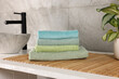 Stack of clean towels on countertop in laundry room