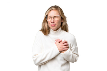 Wall Mural - Young blonde woman over isolated background having a pain in the heart