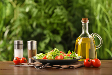 Delicious salad served on wooden table against blurred green background