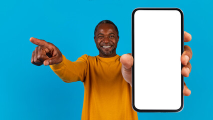 Cool black man showing smartphone with empty screen