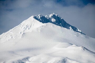 Sticker - Scenic view of a breathtaking mountains covered in snow on a beautiful winter day