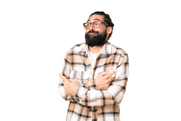 Wall Mural - Young man with beard over isolated chroma key background pointing to the laterals having doubts