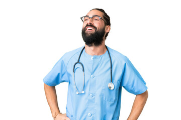 Wall Mural - Young doctor man over isolated chroma key background posing with arms at hip and smiling