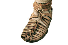 An Ancient Roman Man Legs In Caligae Leather Sandals, Isolated On A White Background. Reconstruction Of The Events Of The Roman Empire