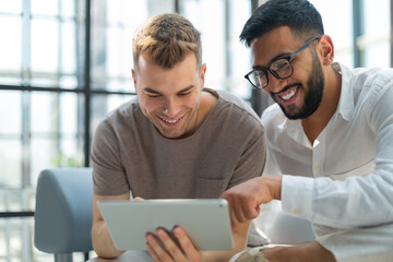 Poster - Happy business colleagues in modern office using tablet