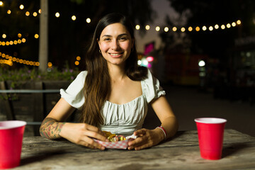 Wall Mural - Beautiful latin woman ordering mexican food at the food cart