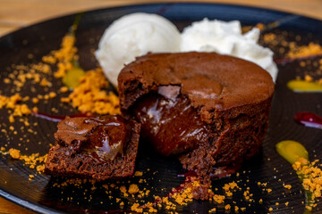 Wall Mural - Plate of delicious warm dessert chocolate cake Fondant served with ice-cream balls. Lava cake on a decorated plate.