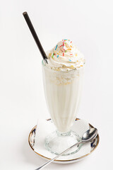 Canvas Print - Milkshake with whipped cream on white background