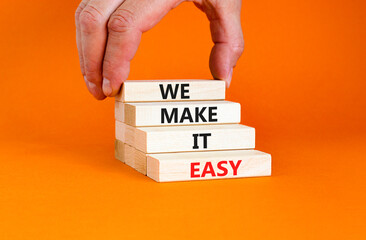we make it easy symbol. concept words we make it easy on wooden cubes. beautiful orange table orange