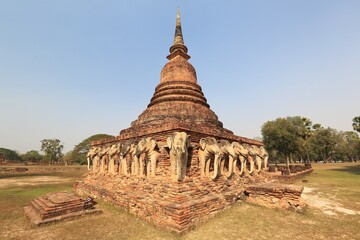 Scenery of Wat Sorasak, an ancient Buddhist Temple with elephant sculptures supporting the base of the stupa, in Sukhothai Historical Park Thailand, a beautiful UNESCO world cultural heritage site