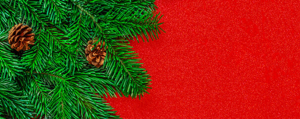 Wall Mural - christmas fit tree on a red shiny background top view, copyspace. xmas, nature new year concept..