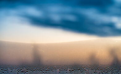 Sticker - condensation from a drop of water on a window pane during an autumn dawn