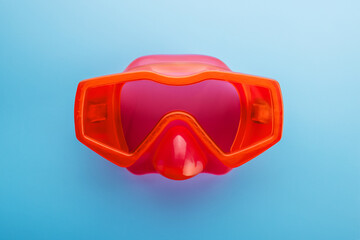 Red swimming mask on a blue background. Mask for diving under water