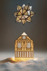 Wall Mural - One paper house with light in snowdrifts and star