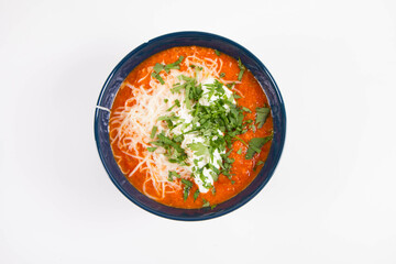 Sticker - Italian tomato soup served with cream, mozzarella cheese and fresh parsley in a bowl, on a white backgound