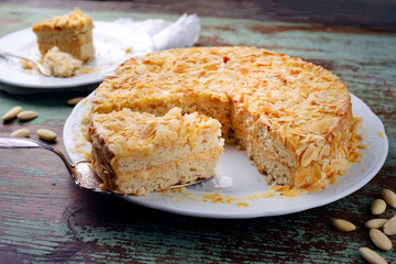 Traditional Swedish almond cake with almond flakes served as close-up on a classic design plate